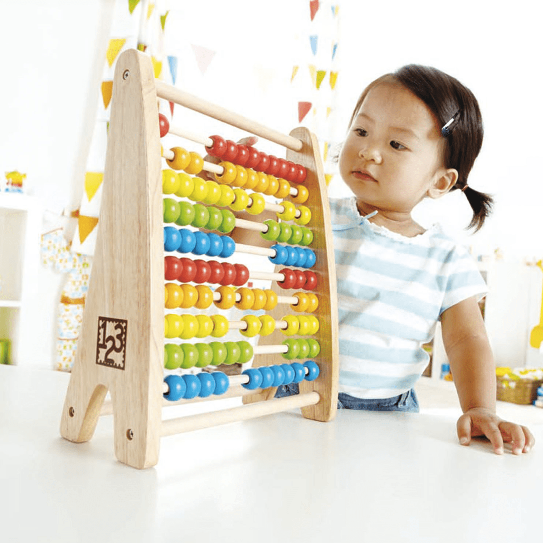 Little-Girl-Playing-With-Hape-Rainbow-Bead-Abacus-Naked-Baby-Eco-Boutique