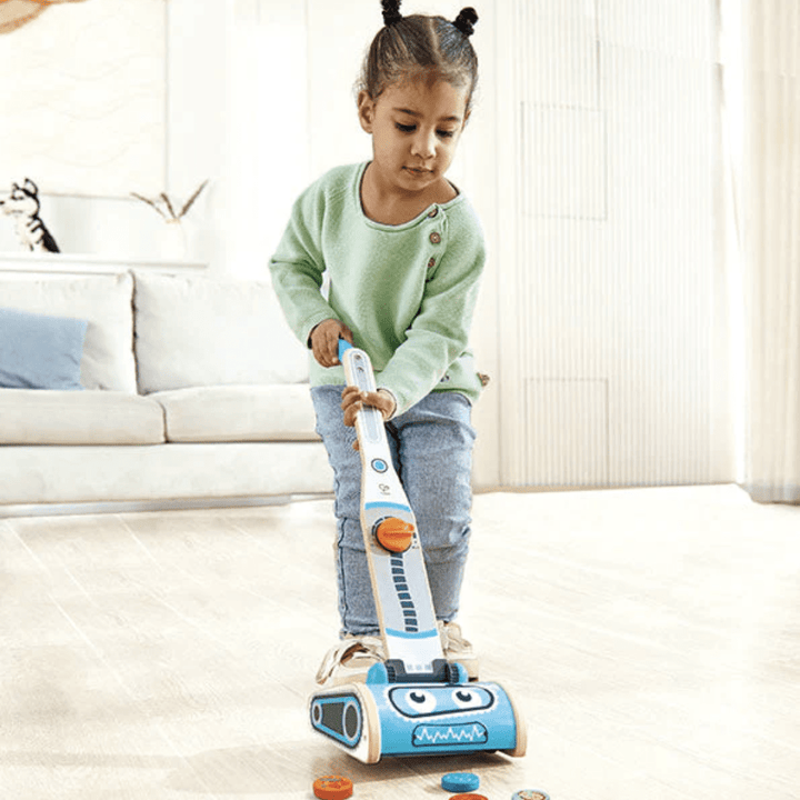 Little-Girl-Playing-With-Hape-Robot-Vacuum-Machine-Naked-Baby-Eco-Boutique