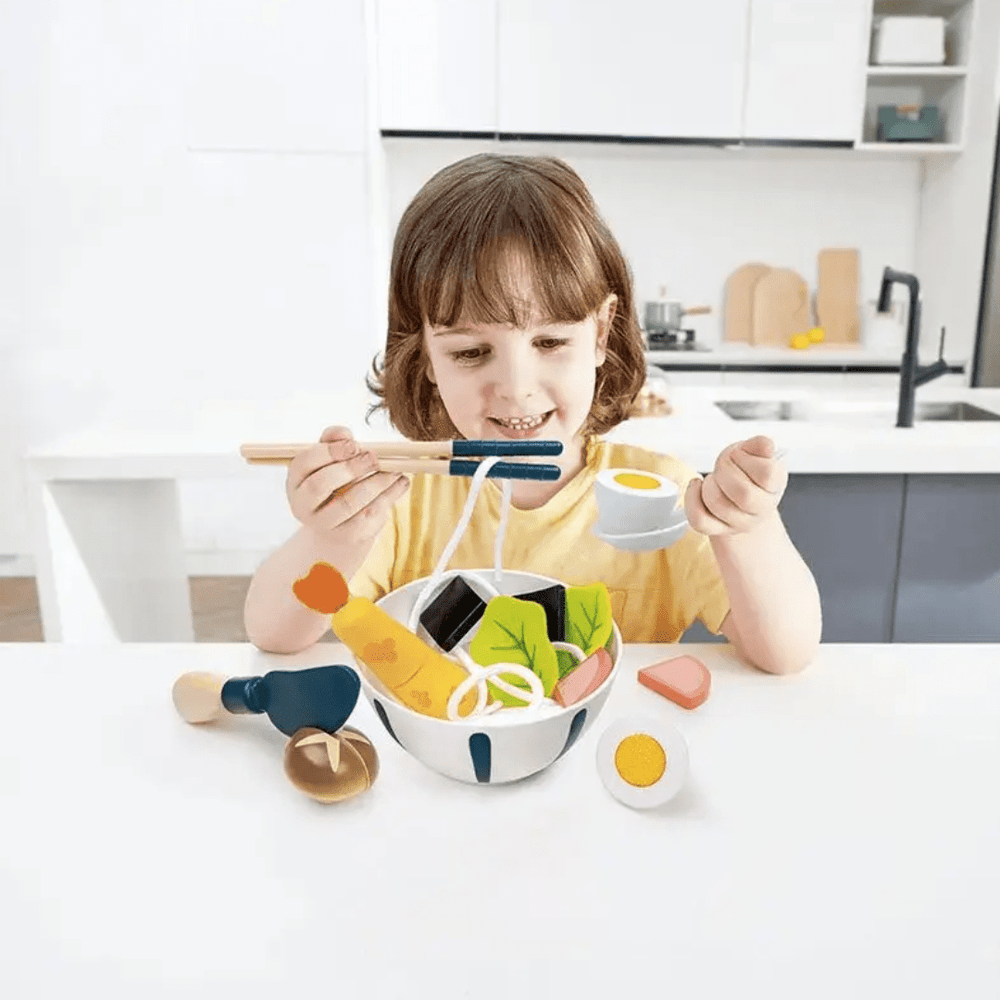 Little-Girl-Playing-With-Hape-Super-Udon-Cooking-Set-Naked-Baby-Eco-Boutique