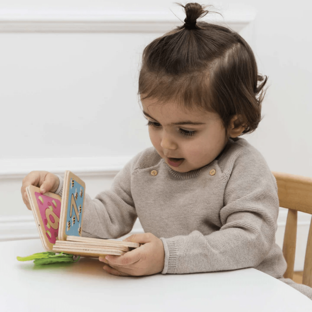 Little-Girl-Playing-With-Le-Toy-Van-Counting-Book-Naked-Baby-Eco-Boutique