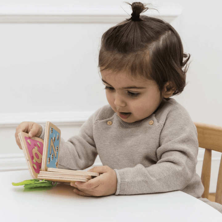 Little-Girl-Playing-With-Le-Toy-Van-Counting-Book-Naked-Baby-Eco-Boutique