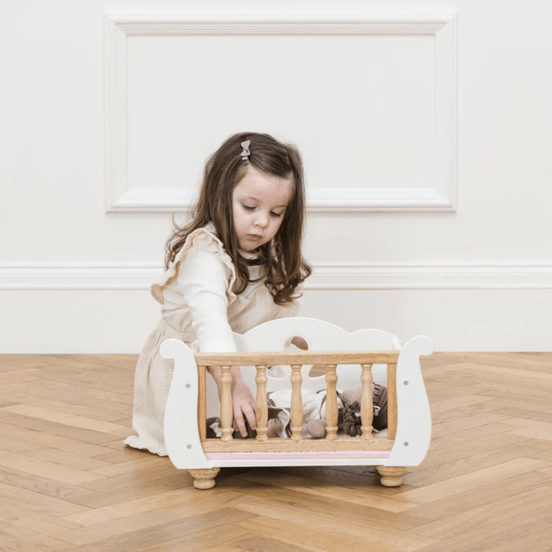 Little-Girl-Playing-With-Le-Toy-Van-Sleigh-Doll-Bed-Naked-Baby-Eco-Boutique
