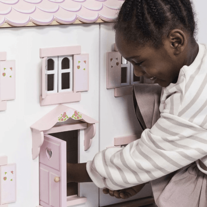 Little-Girl-Playing-With-Le-Toy-Van-Sophies-House-Dollhouse-Naked-Baby-Eco-Boutique