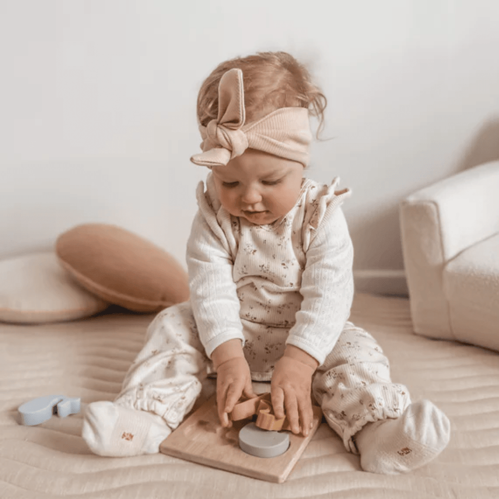 Little-Girl-Playing-With-Over-The-Dandelions-Animal-Puzzle-Naked-Baby-Eco-Boutique