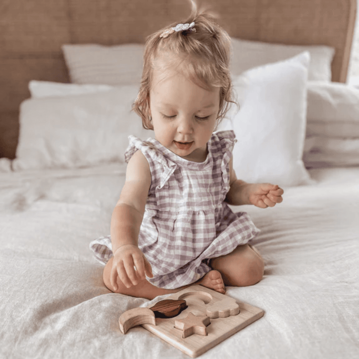 Little-Girl-Playing-With-Over-The-Dandelions-Wooden-Puzzle-Naked-Baby-Eco-Boutique