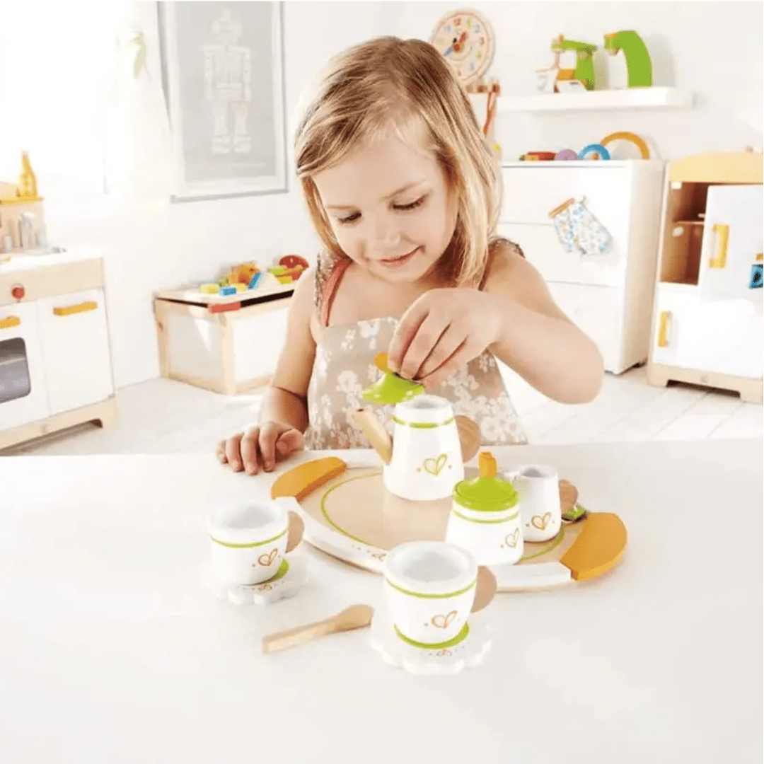 Little-Girl-Playing-With-Tea-Pot-In-Hape-Tea-Set-For-Two-Naked-Baby-Eco-Boutique