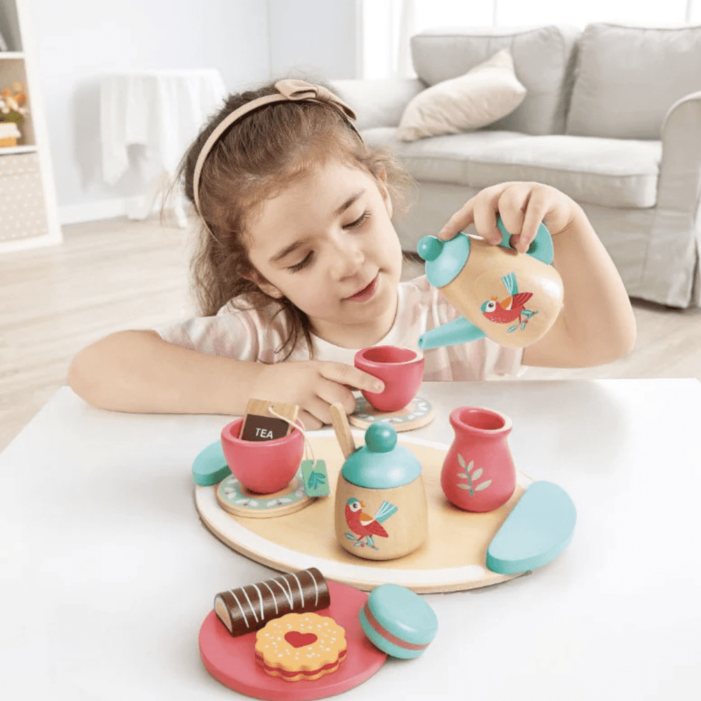 Little-Girl-Pouring-Tea-With-Hape-Tea-Set-Naked-Baby-Eco-Boutique
