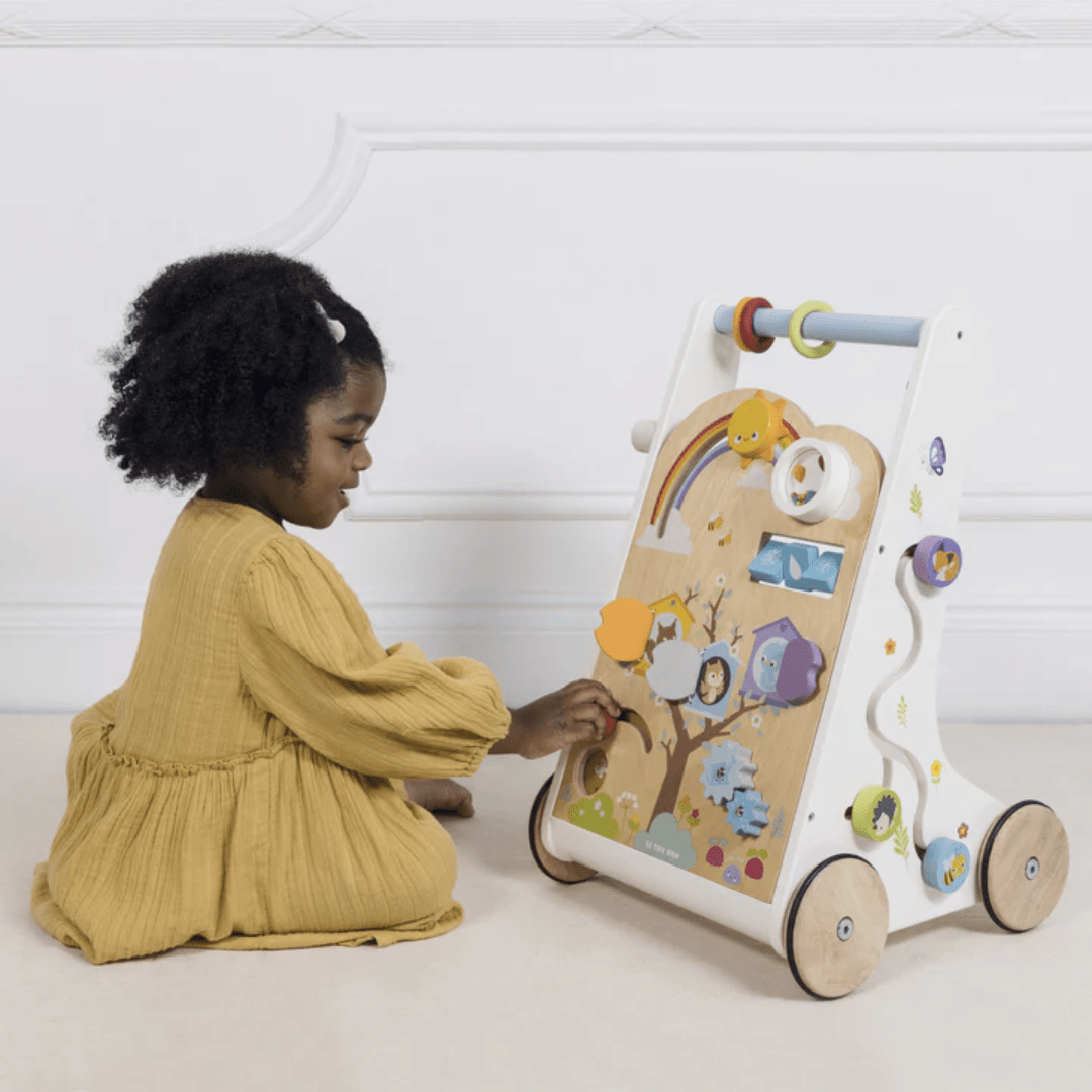 Little-Girl-Sittng-Playing-With-Le-Toy-Van-Activity-Walker-Naked-Baby-Eco-Boutique