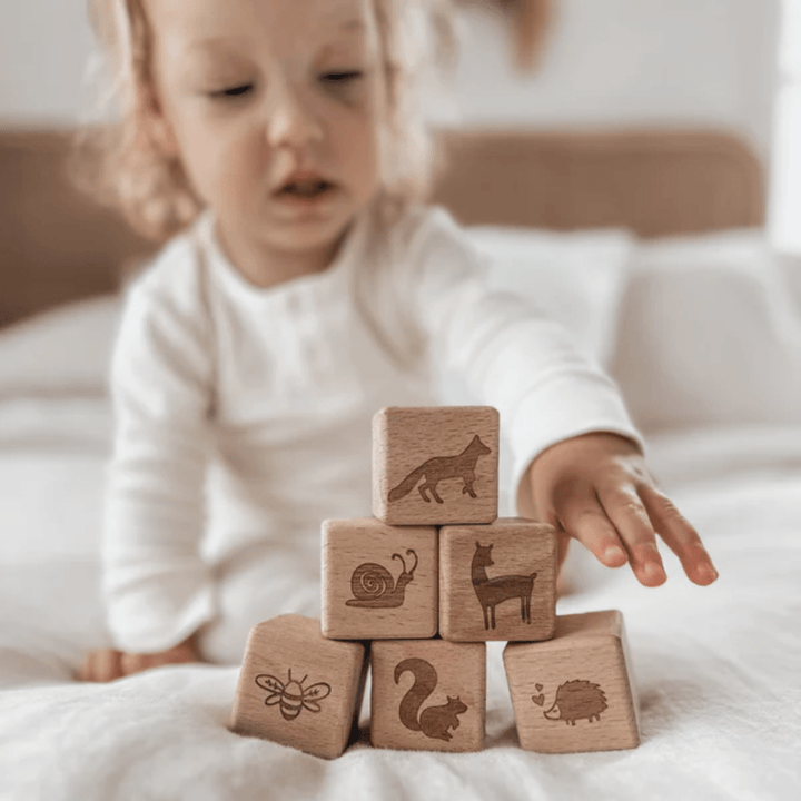 Little-Girl-Stacking-Over-The-Dandelions-Woodlands-Wooden-Block-Set-Naked-Baby-Eco-Boutique