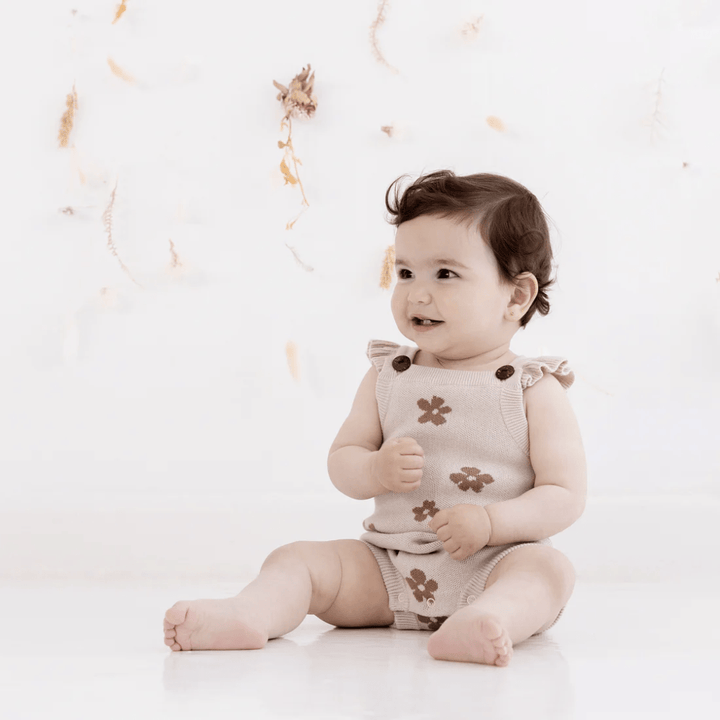 Little-Girl-Wearing-Aster-And-Oak-Organic-Cotton-Flower-Ruffle-Knit-Romper-Naked-Baby-Eco-Boutique