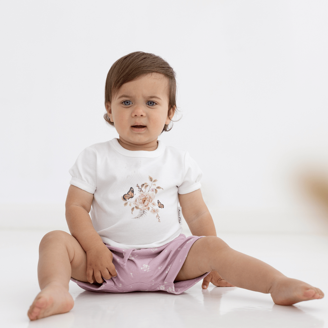 Little-Girl-Wearing-Aster-And-Oak-Organic-Cotton-Print-Top-Butterfly-Garden-Naked-Baby-Eco-Boutique