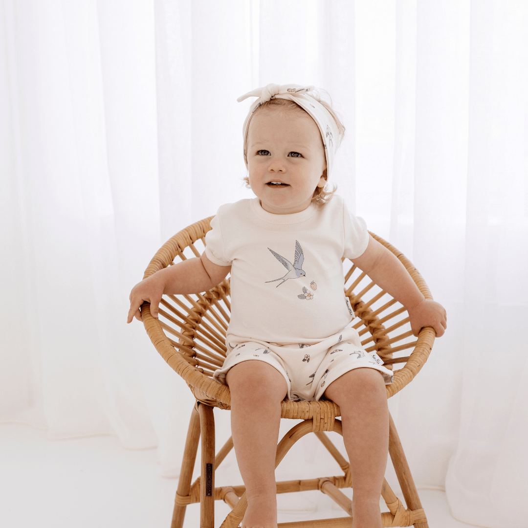 Little-Girl-Wearing-Aster-And-Oak-Organic-Cotton-Print-Top-Swallow-Naked-Baby-Eco-Boutique