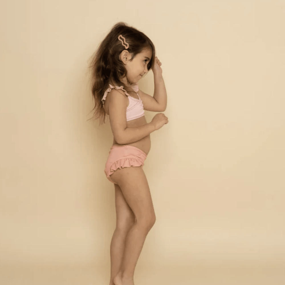 Little-Girl-Wearing-Matching-Swimwear-With-Grech-And-Co-Wave-Hair-Clip-Coral-Rouge-Naked-Baby-Eco-Boutique