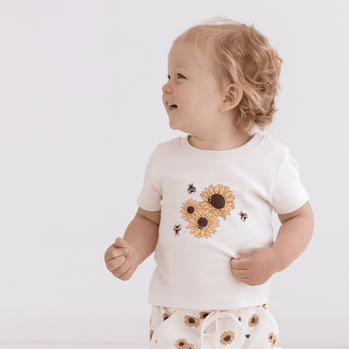 Little-Girl-Wearing-Matching-Top-And-Shorts-Aster-And-Oak-Organic-Cotton-Print-Top-Sunflower-Naked-Baby-Eco-Boutique
