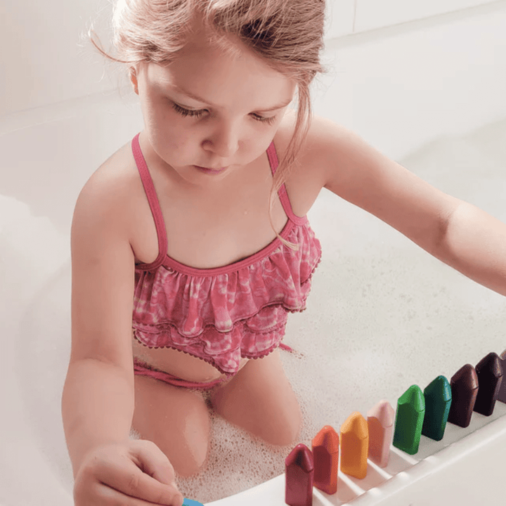 Little-Girl-With-All-Colours-Lined-Up-Drawing-With-Honeystcks-Triangles-Bath-Crayons-Naked-Baby-Eco-Boutique
