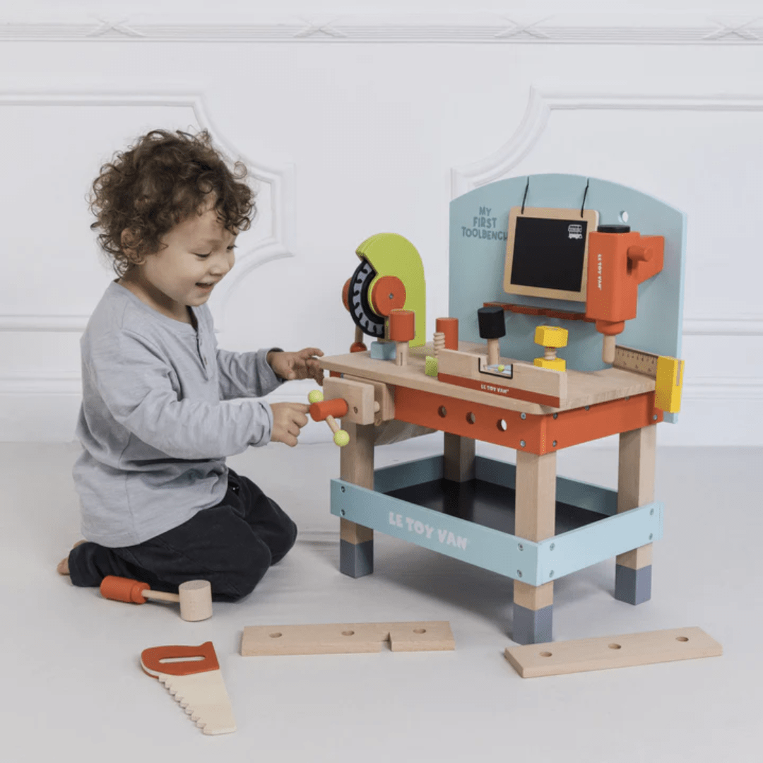 A young boy indulging in DIY dreams while playing with the ethical Le Toy Van My First Tool Bench.