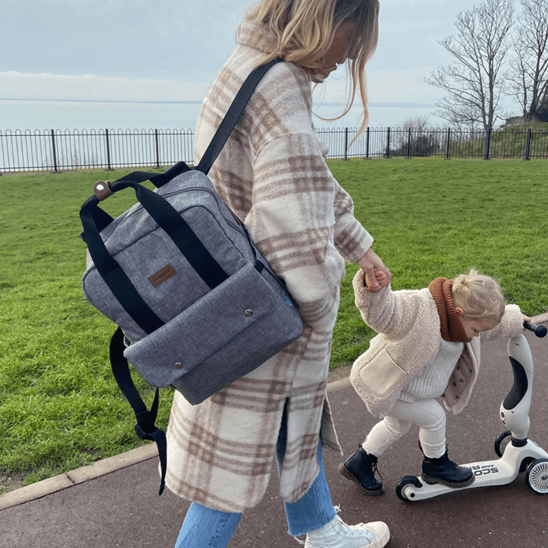 Mum-Walking-Carrying-Babymel-Georgi-Eco-Convertible-Nappy-Backpack-Grey-on-Shoulder-Naked-Baby-Eco-Boutique