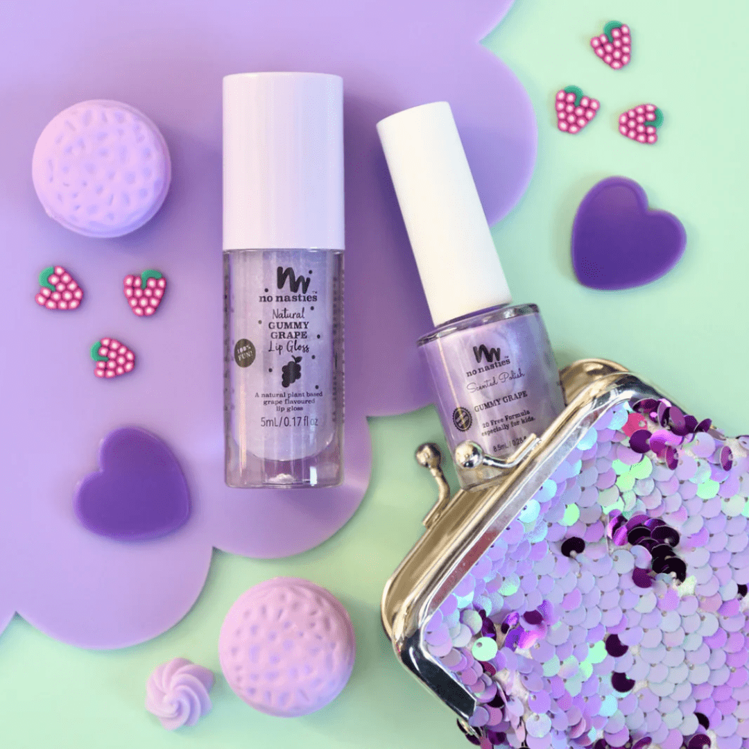 A purple purse with a bottle of No Nasties 20 FREE Kids Scented Nail Polish (Multiple Variants) and a bottle of kids' scented lipgloss.