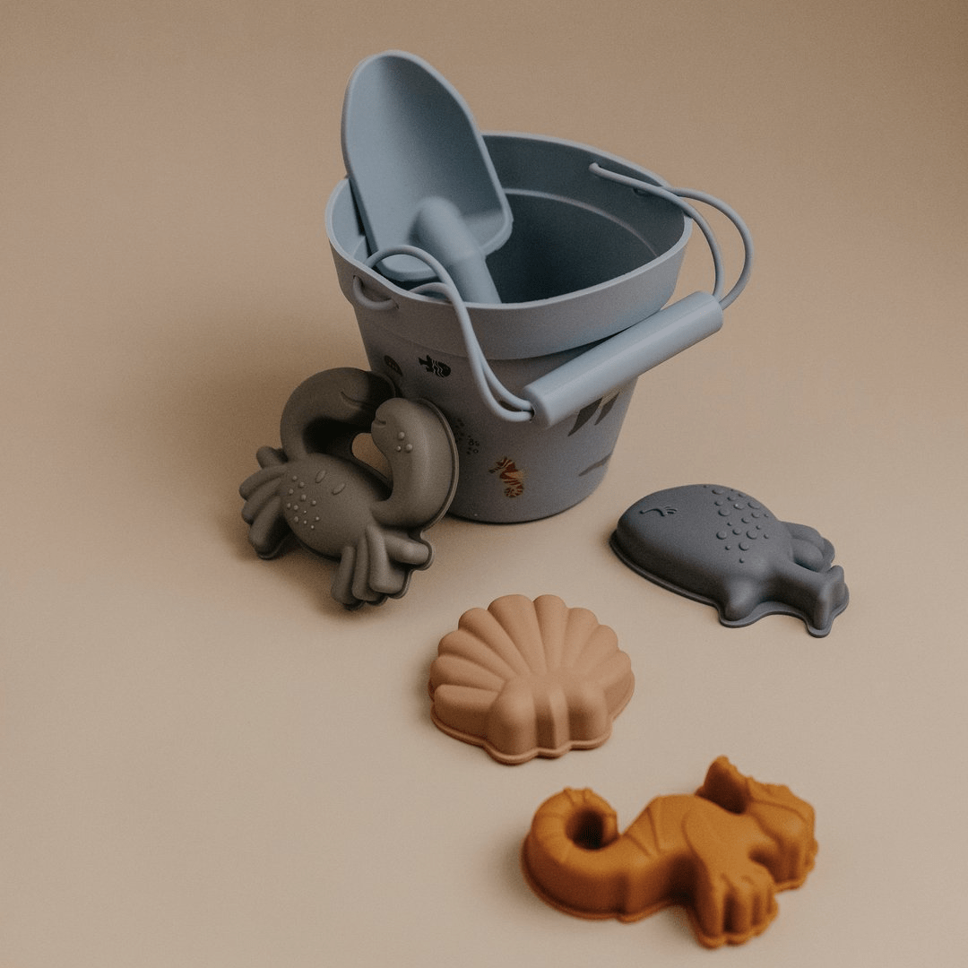 An eco-friendly Classical Child Silicone Sand Set with beach toys and a bucket of sand.
