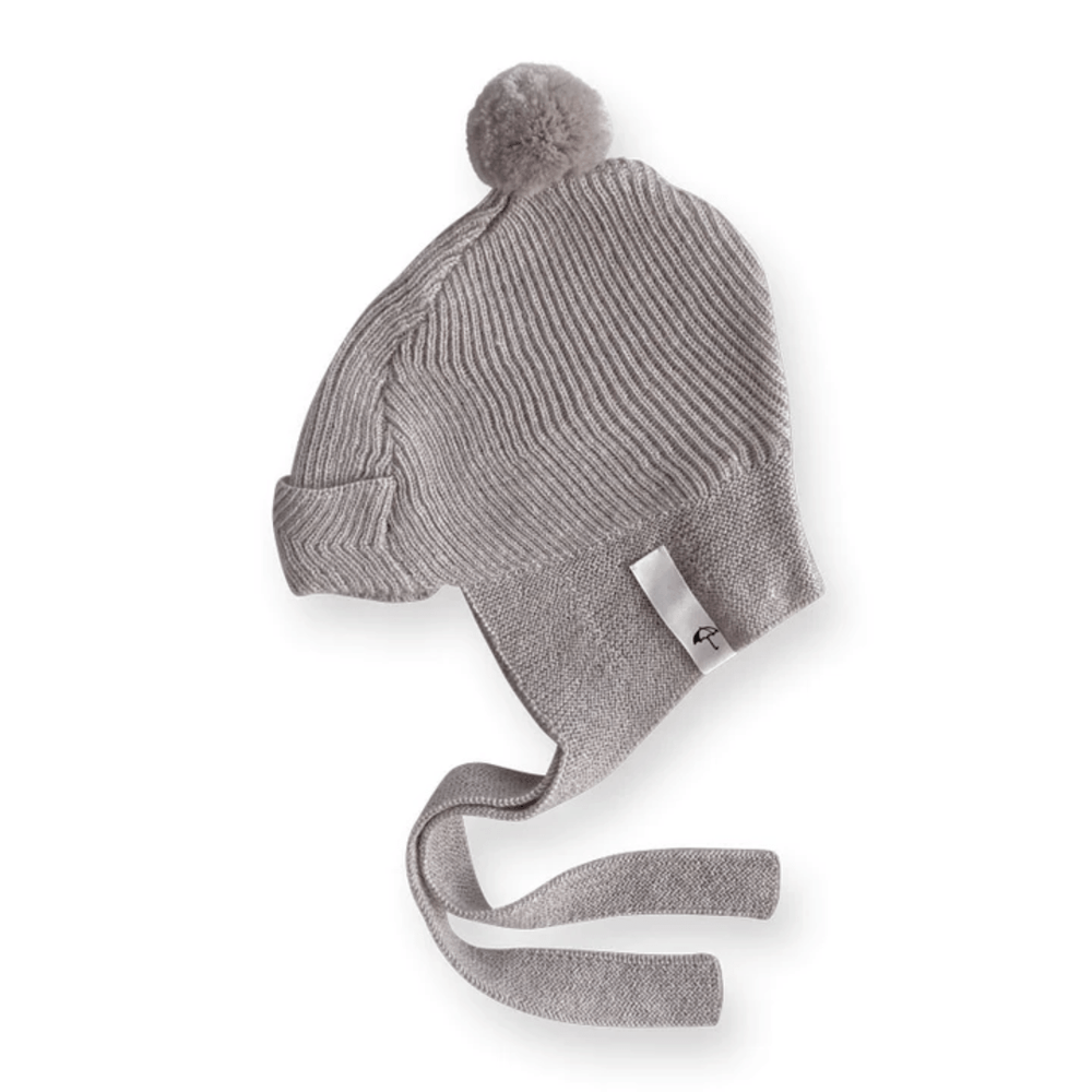 A Saga Copenhagen Merino Bonnet grey knitted hat with a pom pom.