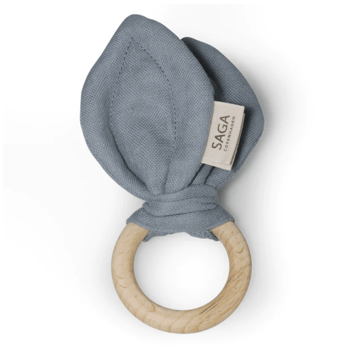 A Saga Copenhagen Organic Cotton + Beechwood Teething Ring, made of beechwood and adorned with blue tooth motif.