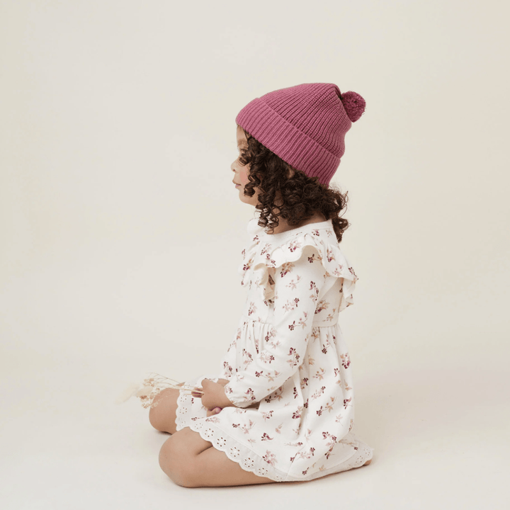 Side-View-of-Child-Wearing-Aster-and-Oak-Organic-Cotton-PomPom-Beanie-Berry-Naked-Baby-Eco-Boutique