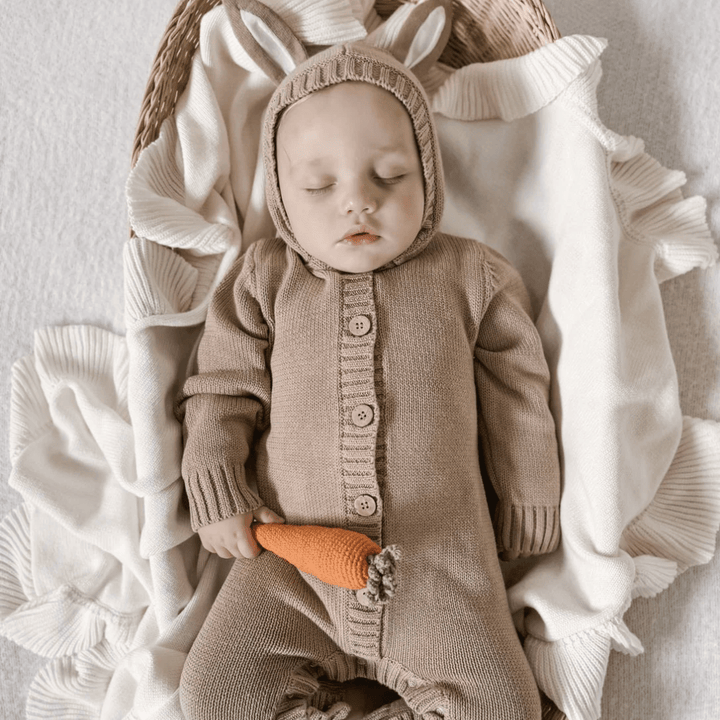Sleepy-Baby-With-Easter-Props-Wearing-Aster-And-Oak-Organic-Bunny-Knit-Romper-Taupe-Naked-Baby-Eco-Boutique