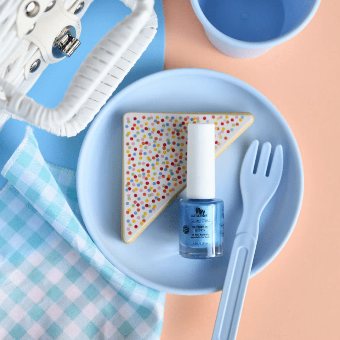 A plate adorned with a bottle of No Nasties 20 FREE Kids Scented Nail Polish and a fork.