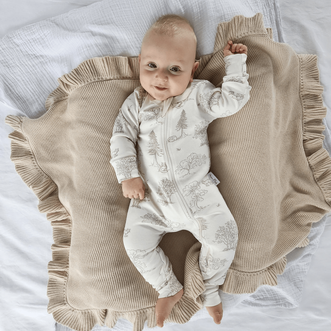 Styled-Image-Of-Little-Baby-Wearing-Aster-And-Oak-Organic-Long-Sleeved-Zip-Romper-Fox-Woods-Naked-Baby-Eco-Boutique