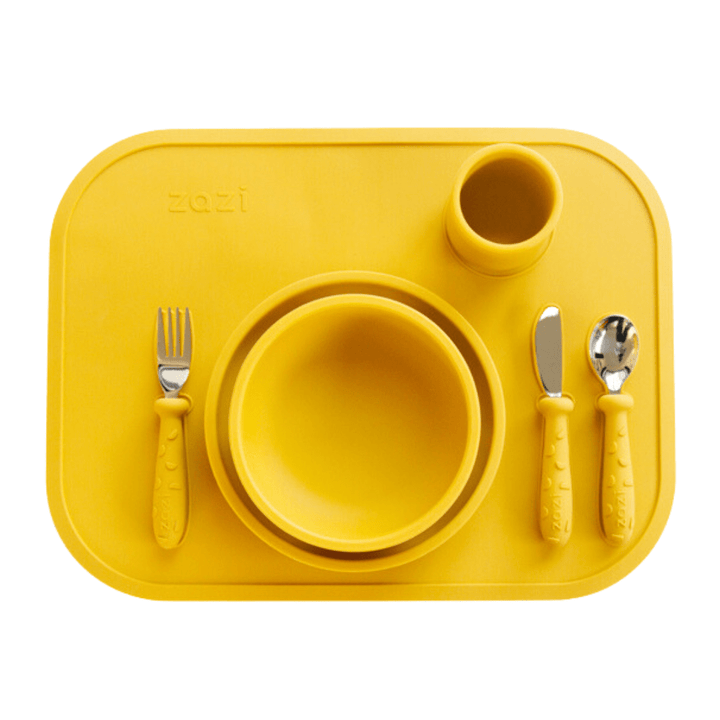A Zazi Clever Mat set with a yellow plate, fork, and knife on a yellow tray.