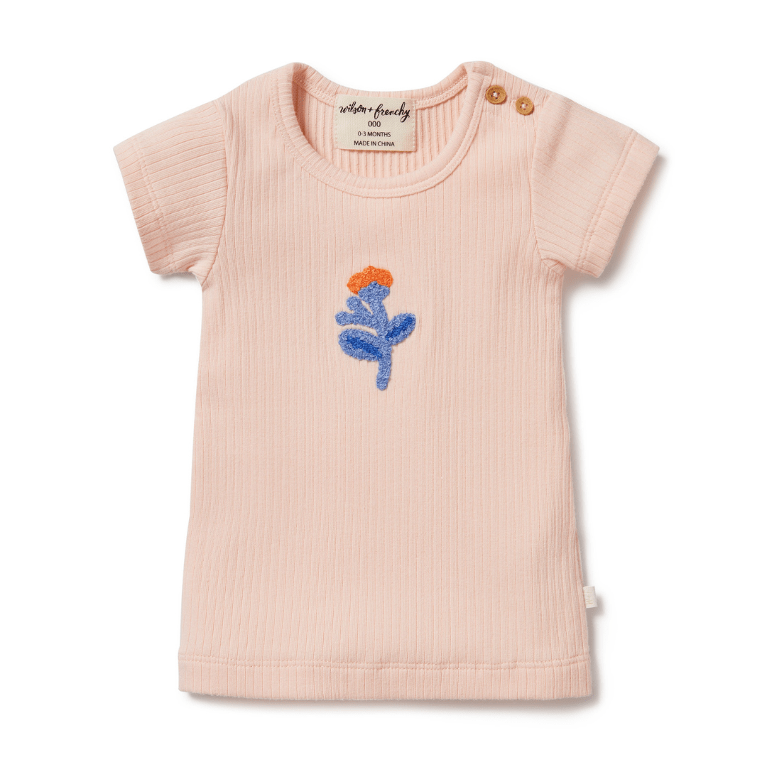 A Wilson & Frenchy Little Flower Organic Rib Tee, with a blue flower embroidered on it.