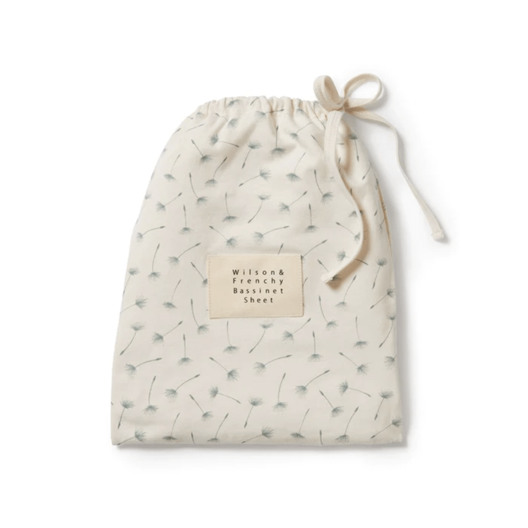 Cream-colored drawstring bag, an outlet item, with a small label and a green sprig pattern. Wilson & Frenchy Organic Cotton Bassinet Sheet - LUCKY LAST - HELLO JUNGLE ONLY.
