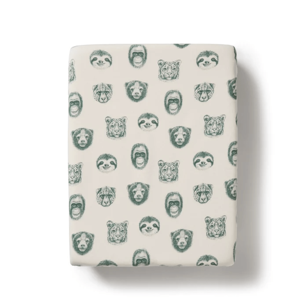 A folded Wilson & Frenchy organic cotton blend fabric with animal face pattern on a plain background.