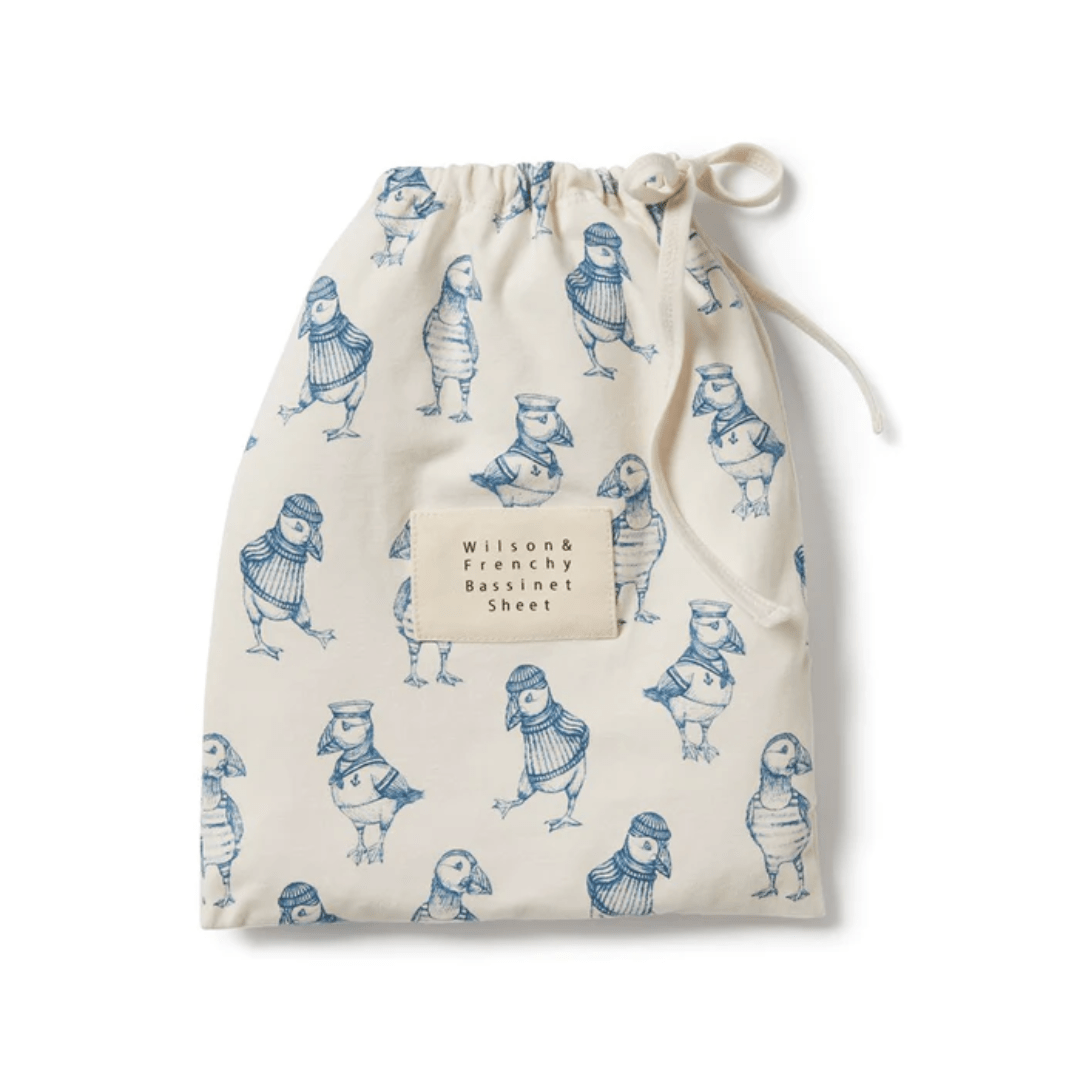 A drawstring bag with bird print and text "Wilson & Frenchy Organic Cotton Bassinet Sheet - LUCKY LAST - HELLO JUNGLE ONLY" on it.