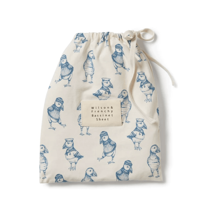 A drawstring bag with bird print and text "Wilson & Frenchy Organic Cotton Bassinet Sheet - LUCKY LAST - HELLO JUNGLE ONLY" on it.