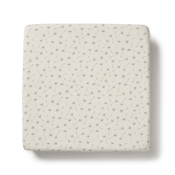 A Wilson & Frenchy Organic Cotton Cot Sheet - LUCKY LASTS - FLOAT AWAY ONLY, perfect as a baby shower present, featuring a white square with a blue and white pattern on it.