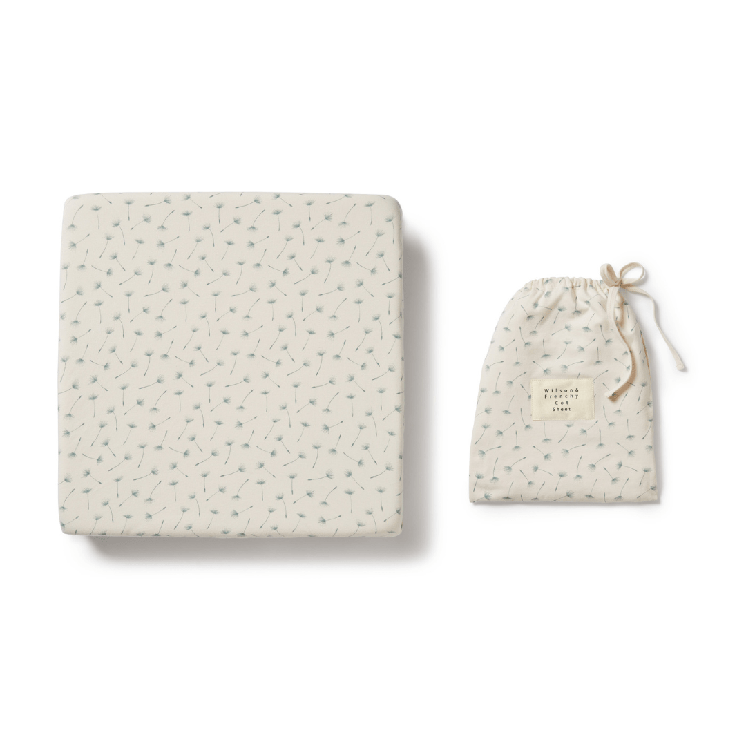A Wilson & Frenchy Organic Cotton Cot Sheet - LUCKY LASTS - FLOAT AWAY ONLY featuring blue arrows, perfect as a baby shower present.