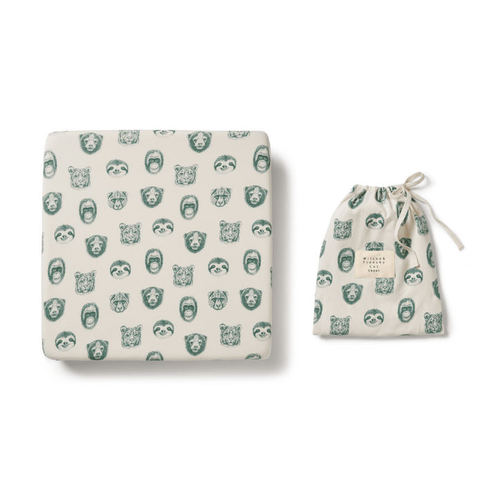 An Wilson & Frenchy Organic Cotton Cot Sheet - LUCKY LASTS - FLOAT AWAY ONLY with a green print and a bag. Perfect as a baby shower present.