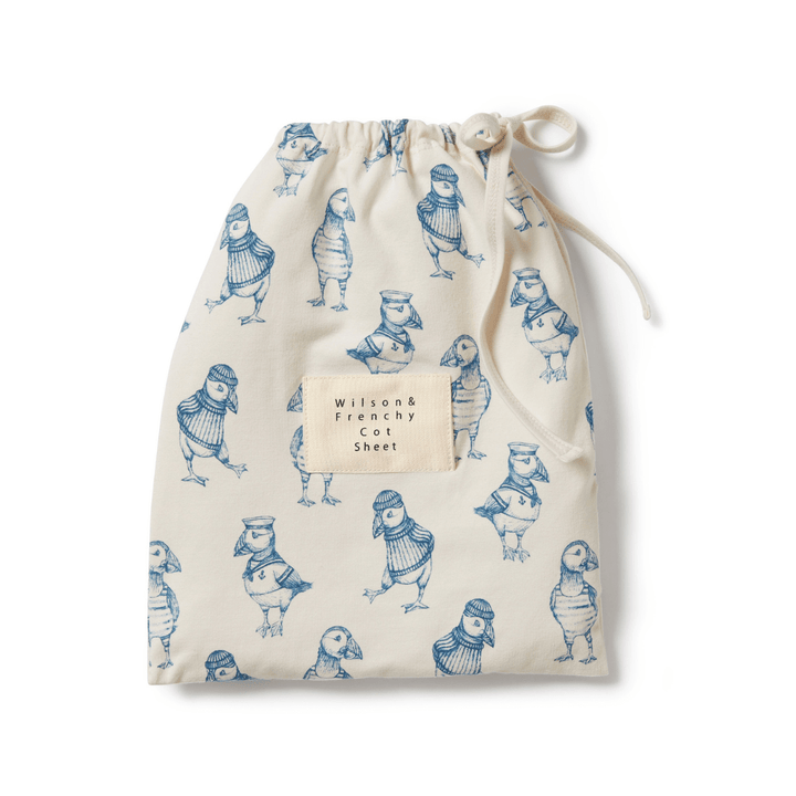 A Wilson & Frenchy organic cotton blend bag with blue cartoon characters on it, perfect as a baby shower present.