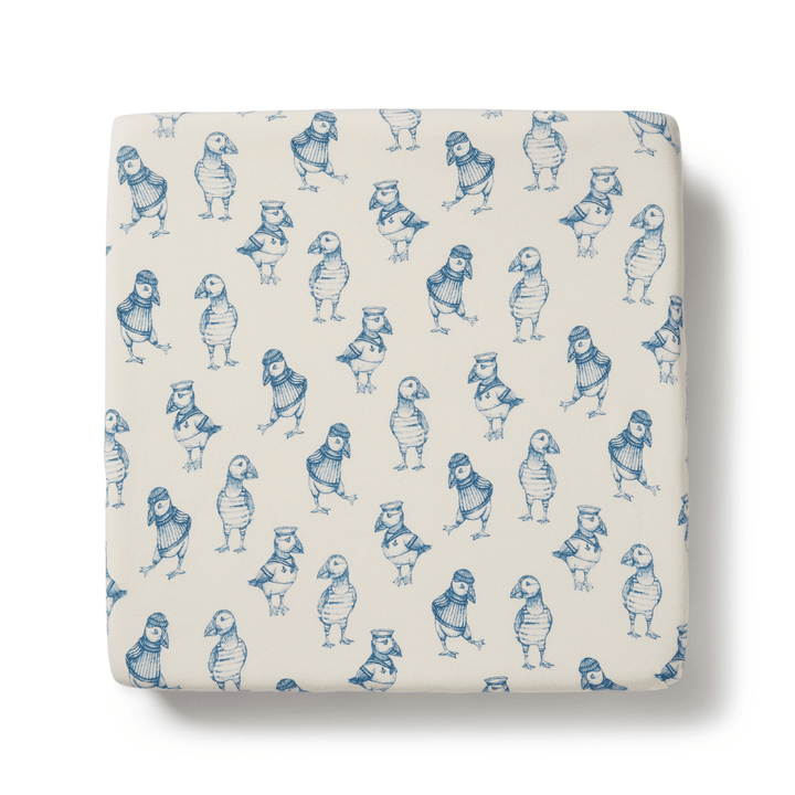 A Wilson & Frenchy Organic Cotton Cot Sheet - LUCKY LASTS - FLOAT AWAY ONLY, a square object with blue and white designs, perfect as a baby shower present.
