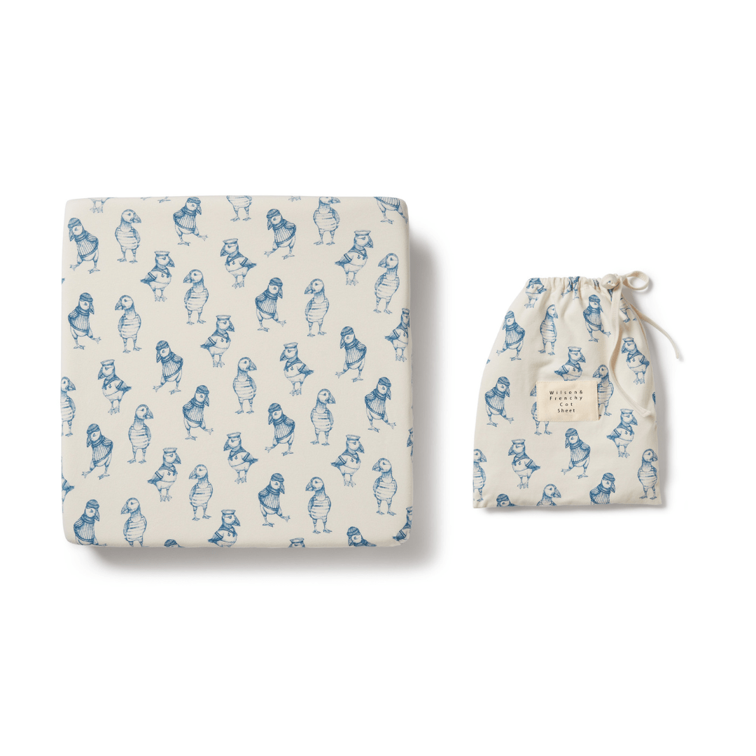 A Wilson & Frenchy Organic Cotton Cot Sheet - LUCKY LASTS - FLOAT AWAY ONLY, a blue and white baby blanket with an organic cotton blend.