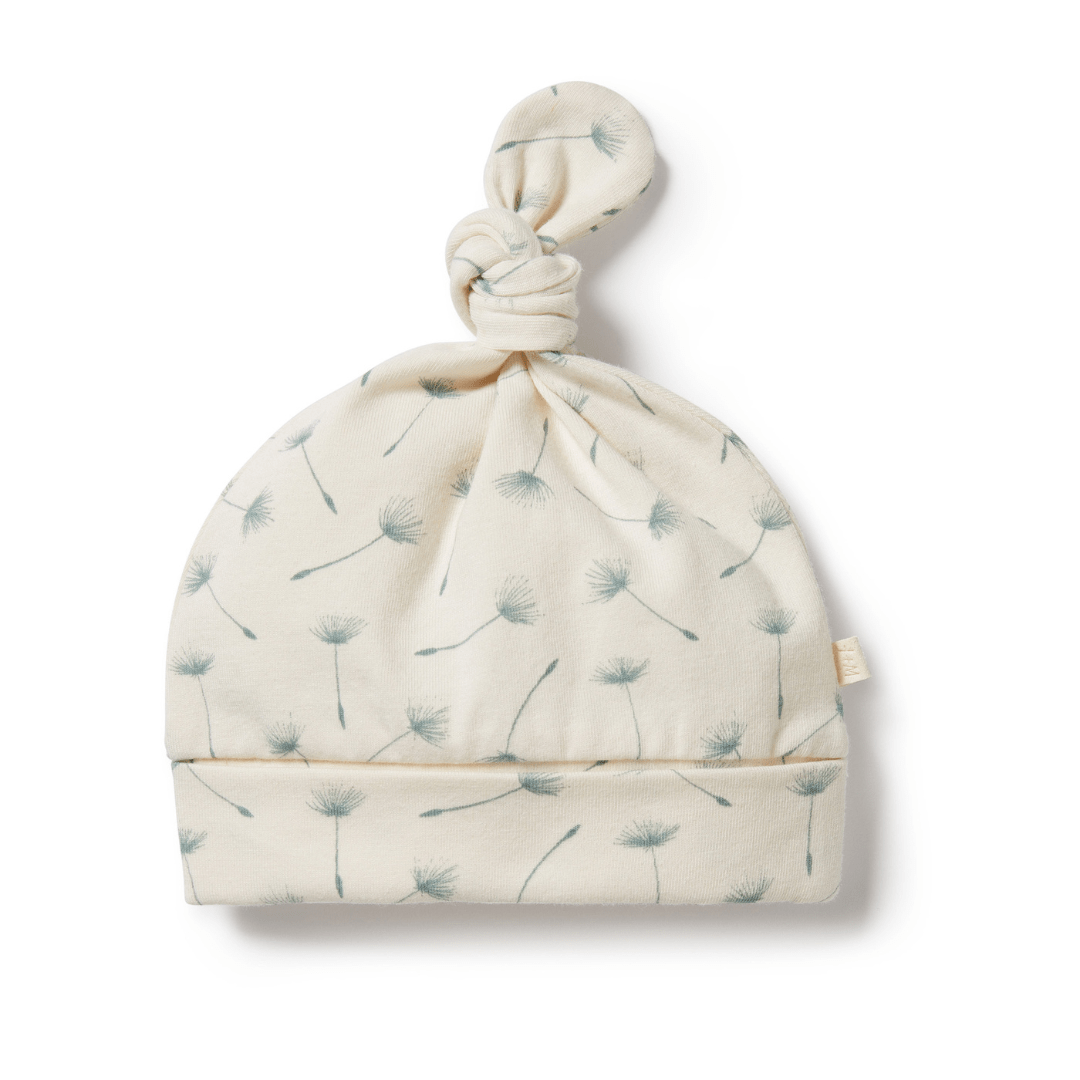 Baby's Wilson & Frenchy Organic Knot Hat made of organic cotton with dandelion print on a white background.