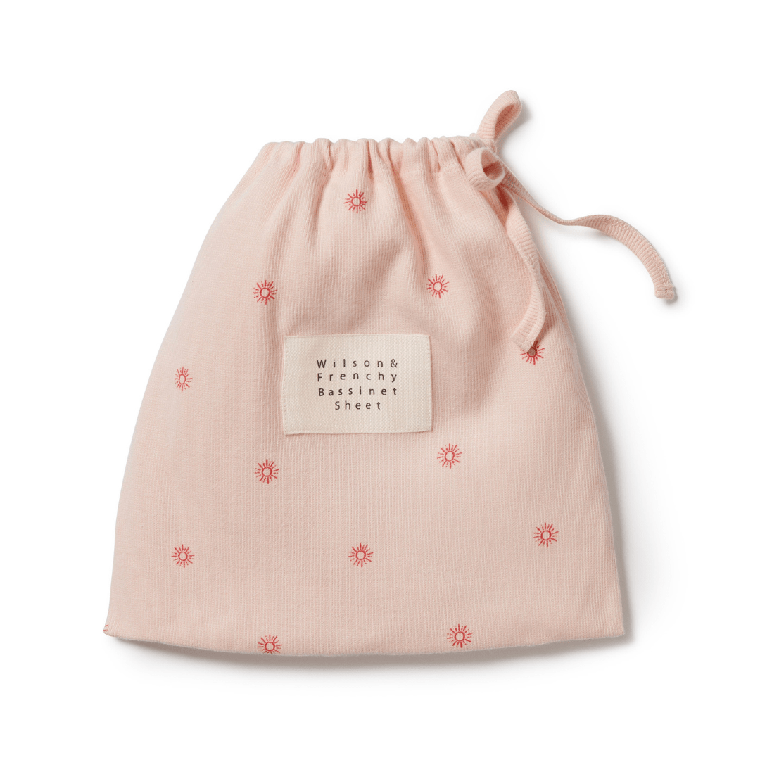 Pink drawstring bag with labeled patch and decorative star patterns, Wilson & Frenchy Organic Rib Bassinet Sheet - LUCKY LASTS - SHINE ON ME & SUMMER DAYS ONLY, available at an outlet.