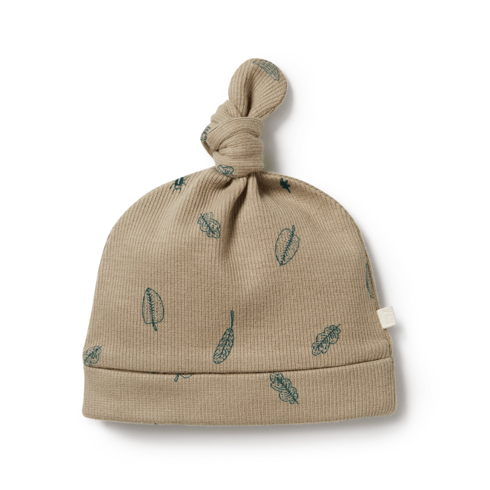 A Wilson & Frenchy Organic Rib Knot Hat with leaves on it.