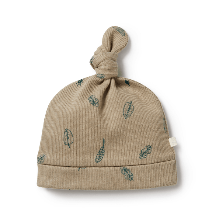 A Wilson & Frenchy Organic Rib Knot Hat with leaves on it.