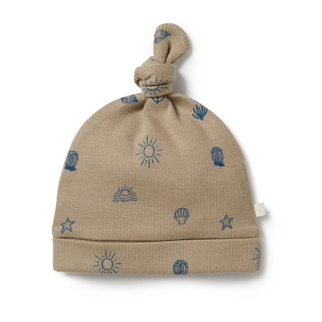 A beige Wilson & Frenchy Organic Rib Knot Hat with a sun and sea print.
