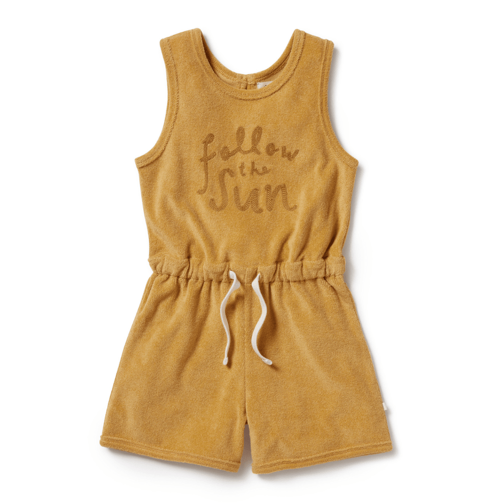 A Wilson & Frenchy Organic Terry Kids Playsuit in mustard with the word follow me sun on it.