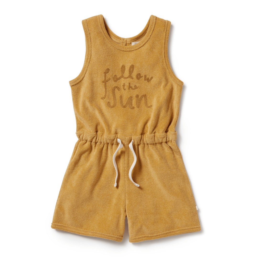 A Wilson & Frenchy Organic Terry Kids Playsuit in mustard with the word follow me sun on it.
