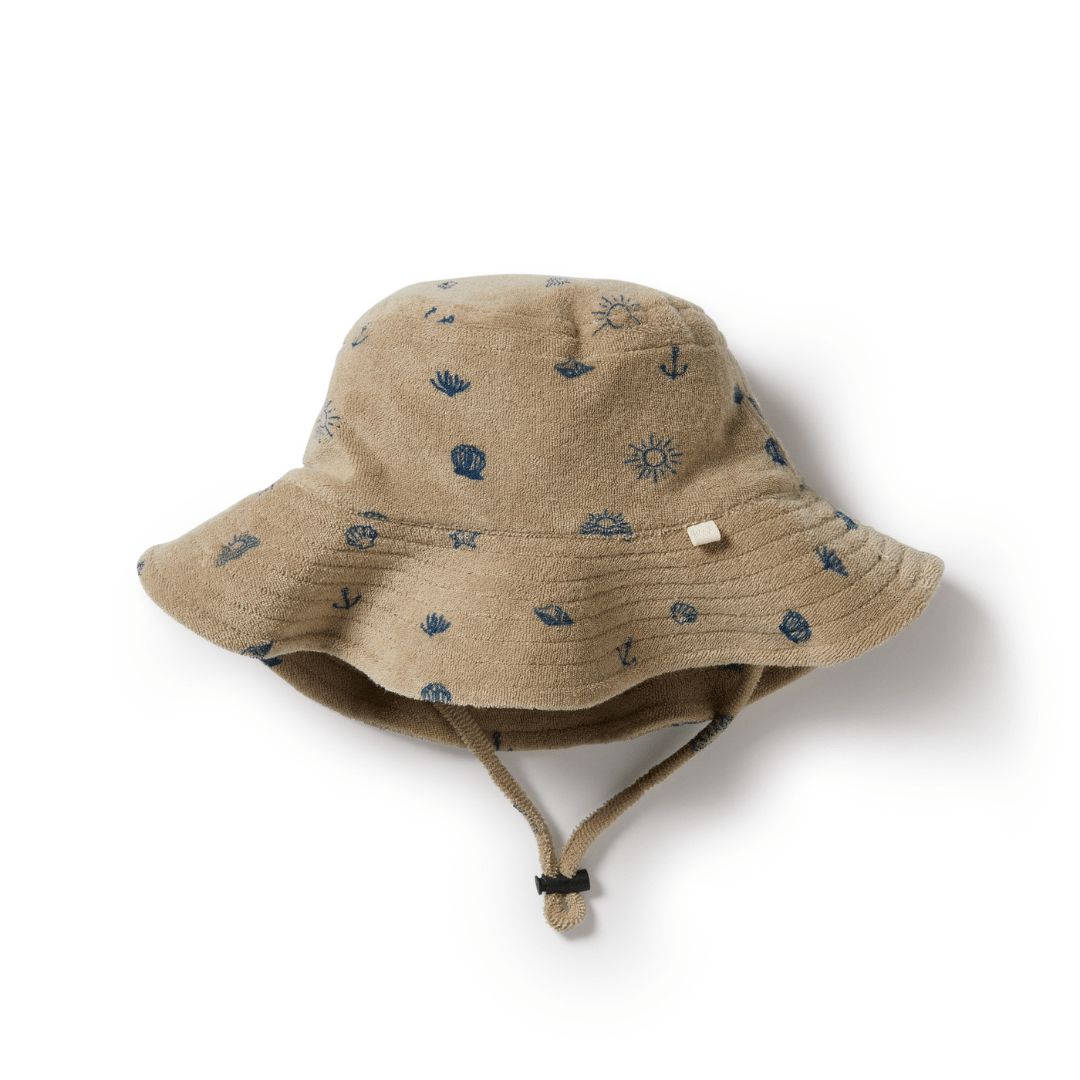 A Wilson & Frenchy Organic Terry Kids Sunhat with blue stars, perfect for beach-day.