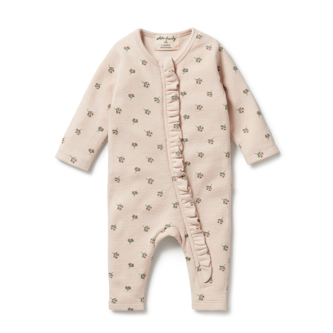 Wilson & Frenchy Organic Waffle Ruffle Zipsuit with a floral pattern on a white background, made from GOTS-certified organic cotton.